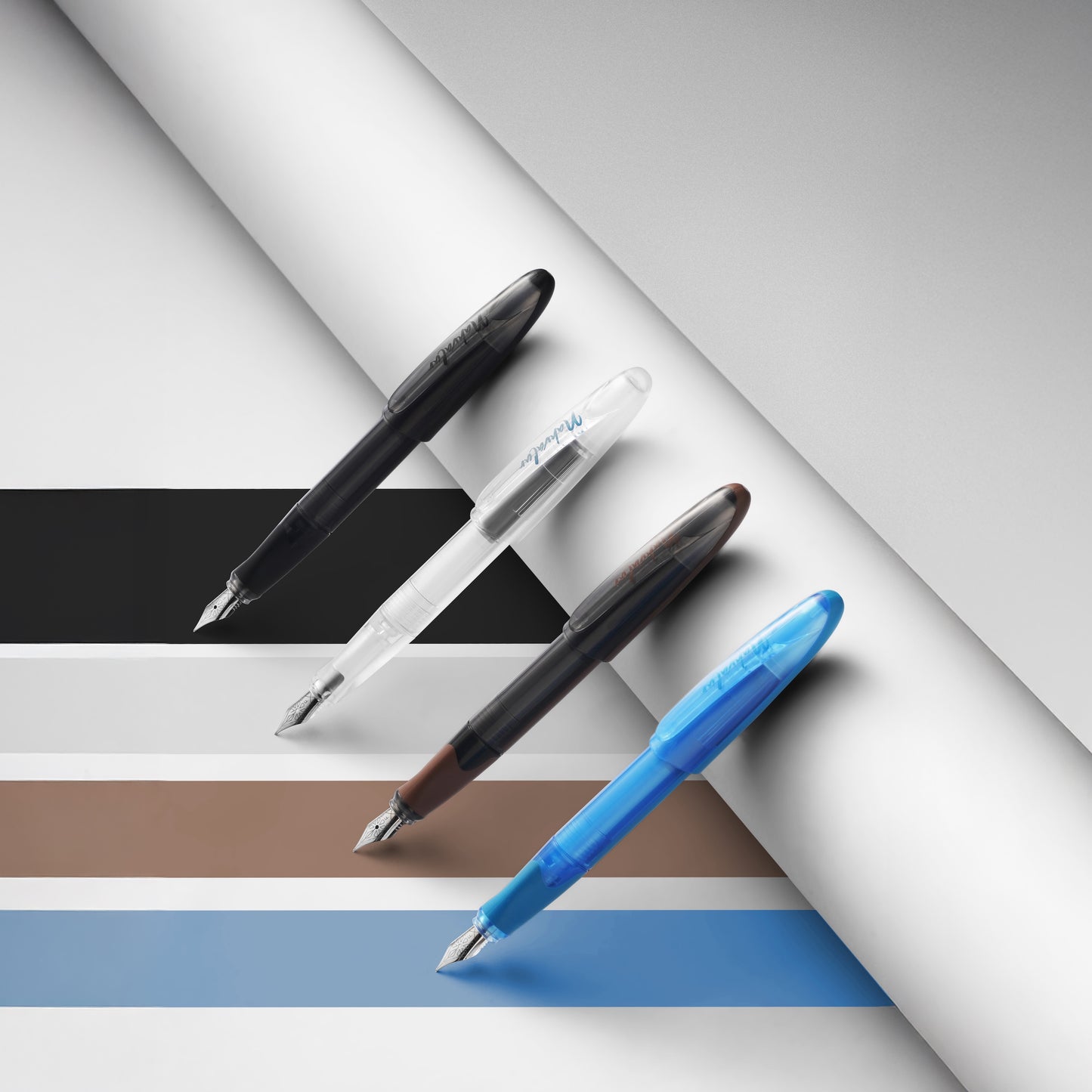 Four pens of different colors on a striped background