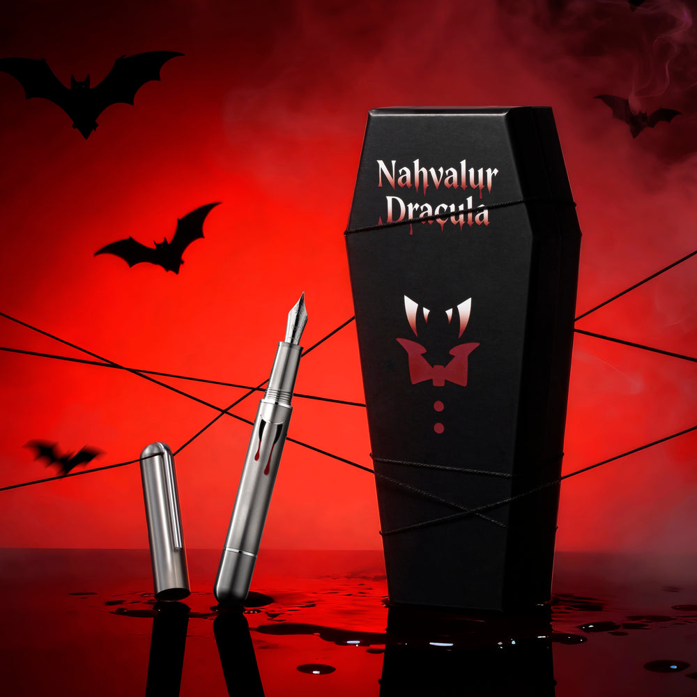 
                  
                    Fountain pen and coffin-shaped box with 'Nahvalur Dracula' branding on a red background with bats and spider webs.
                  
                