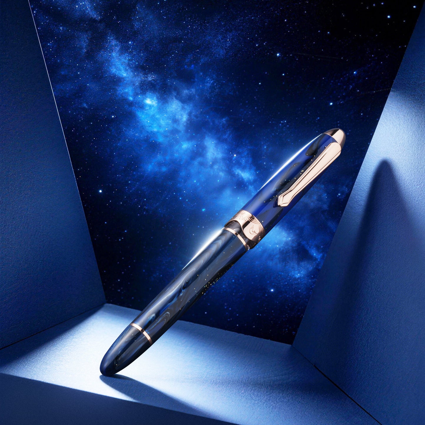 Pen with a gold accent against a starry night sky background