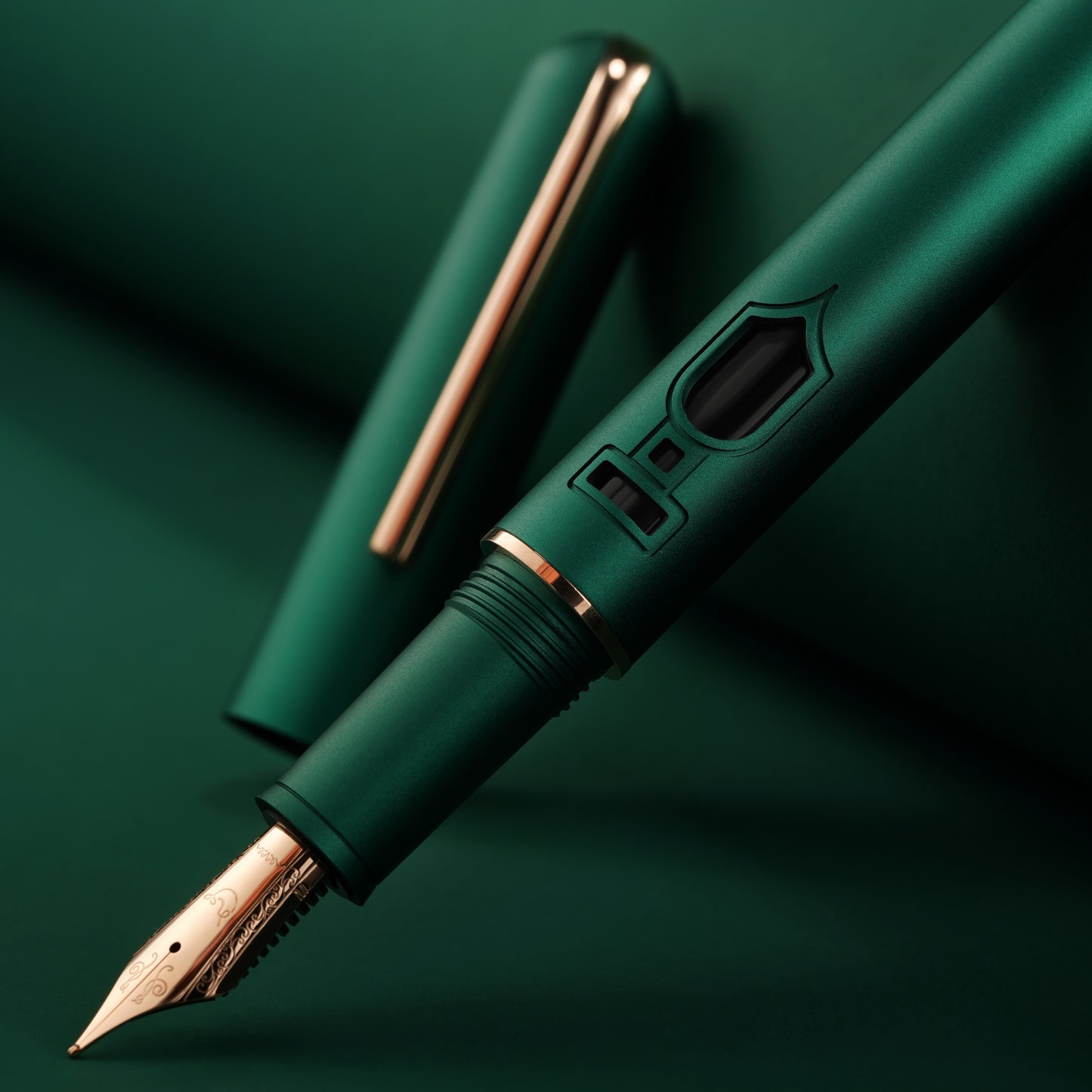 
                  
                    Green fountain pen with rose gold accents on a green background
                  
                