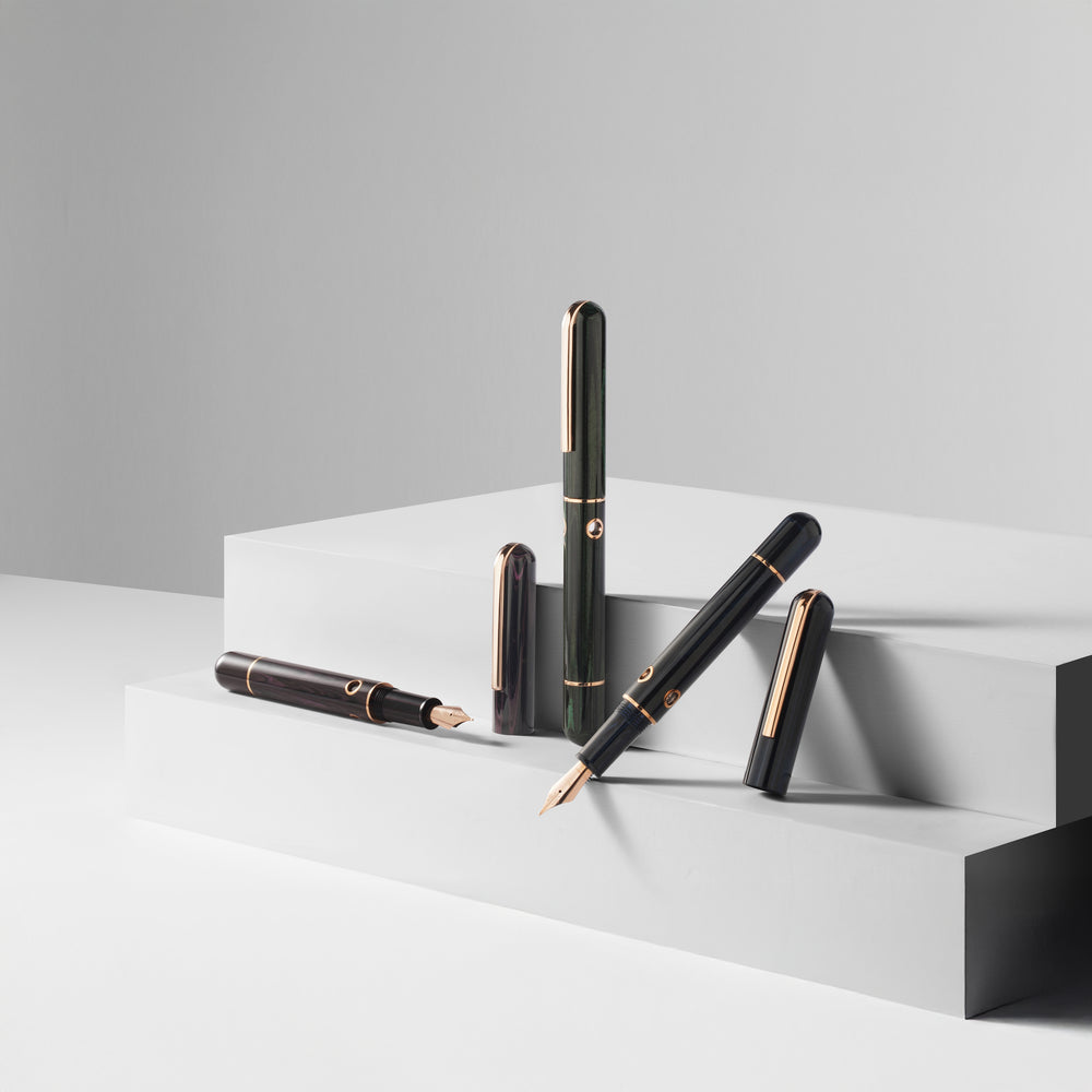 
                  
                    Set of pens on a white platform with a gray background
                  
                