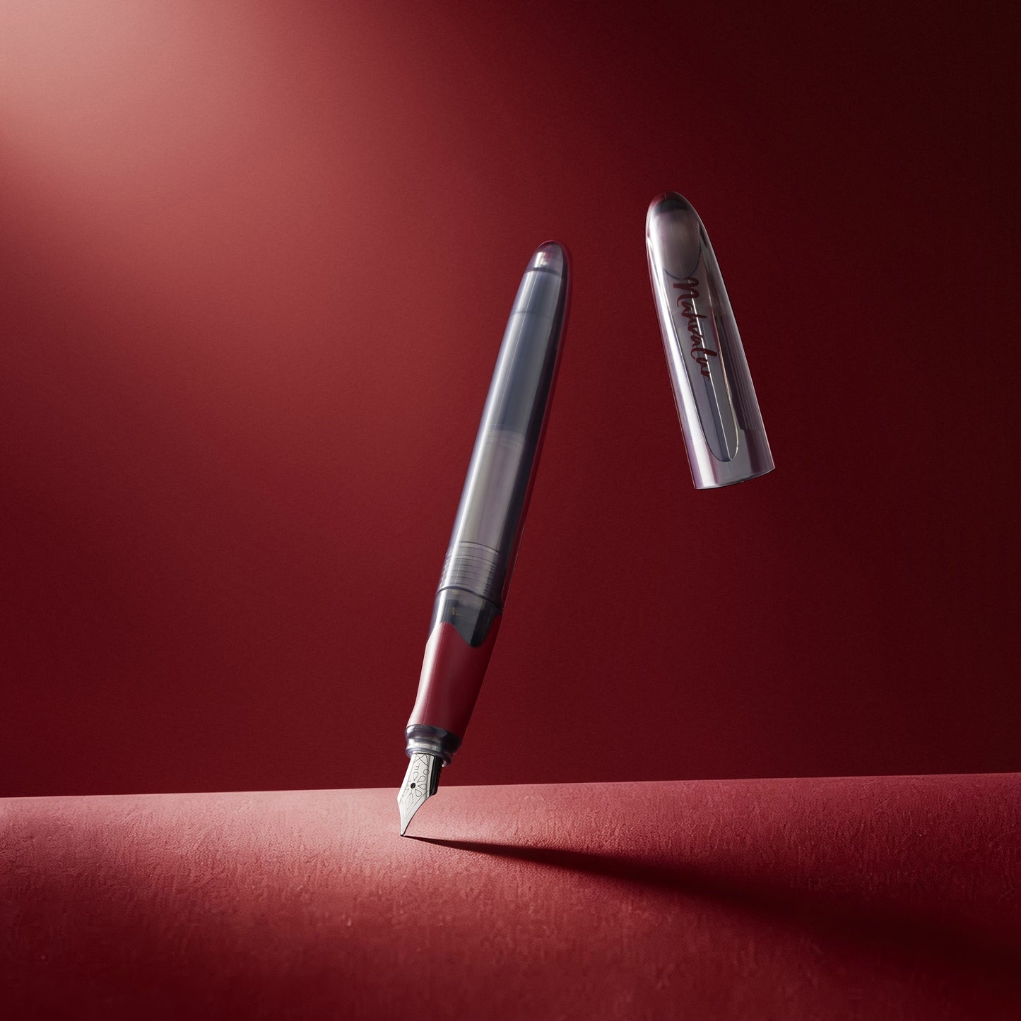 Fountain pen with cap on a red background